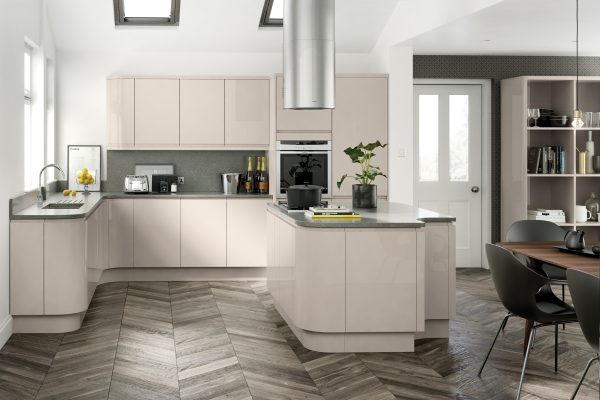 Handleless high gloss cashmere kitchen with smooth reflective cabinets and light worktops in a sleek, contemporary layout.