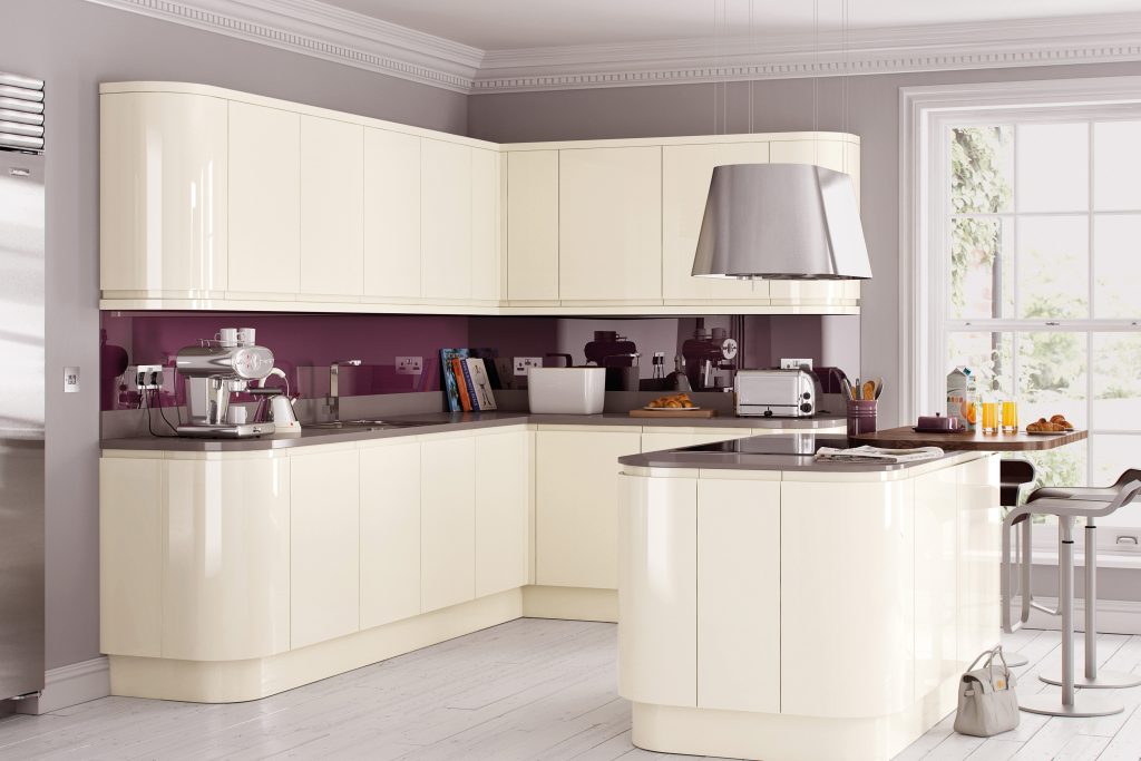 Contemporary kitchen design featuring cream gloss handleless cabinets and integrated soft-closing drawer units.