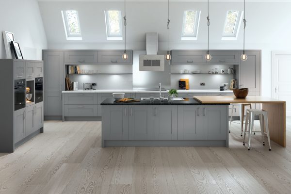 Dust grey shaker kitchen with refined details and light worktops, offering an elegant, welcoming space.