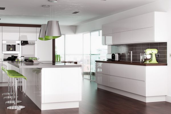 Bright contemporary kitchen design featuring glacier white gloss handleless cabinets and soft-closing drawer units.